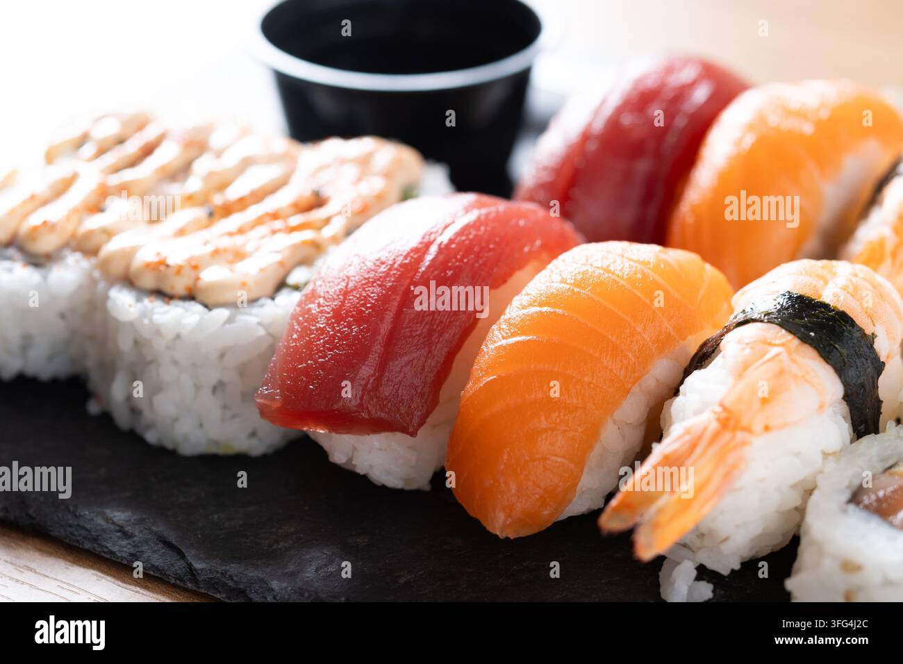Assorted nigiri arranged on a wooden board